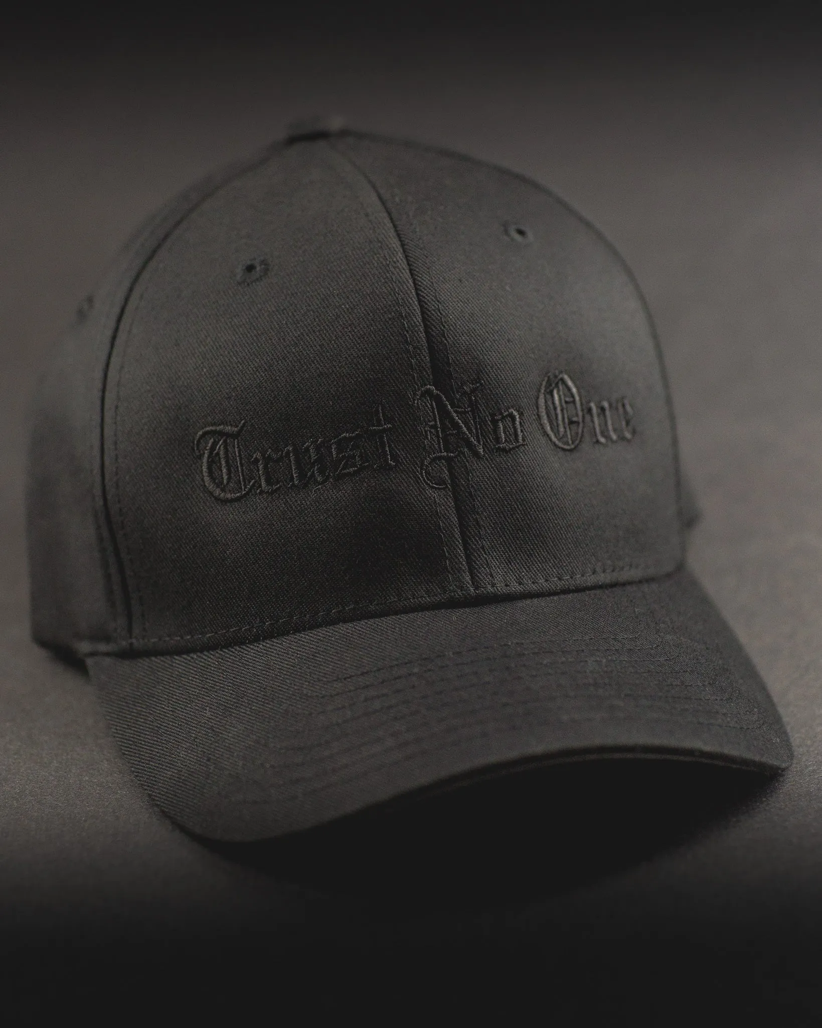 Trust No One Structured Curved Bill Flexfit Hat - Black on Black